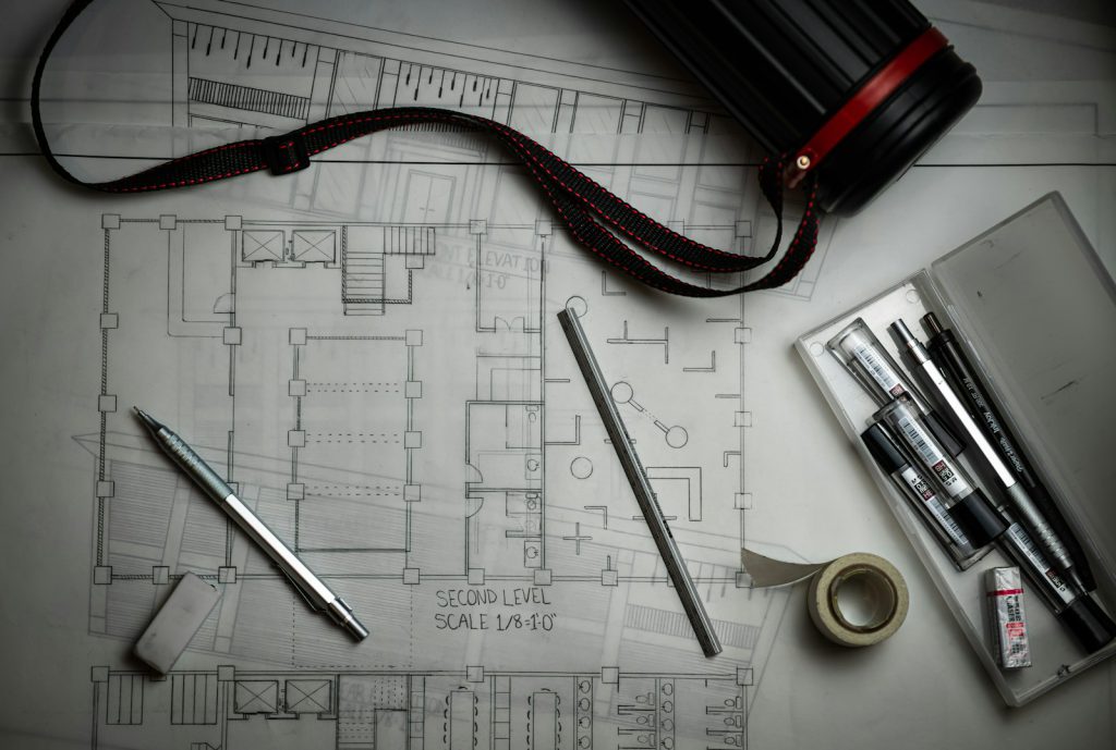 Architectural plans and drafting tools used to assess a property